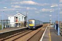 A warm Spring afternoon at Shippea Hill in May 2011 sees a 3-car DMU passing over the level crossing heading for Norwich. At this time the refurbished Victorian signal box was looking as good as it had for some years [see image 41463]. [The 'box was decommissioned following the installing of automatic barriers here in the summer of 2012.]   <br><br>[Ian Dinmore 21/05/2011]