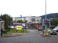 Privately owned class 08 shunter 08788 propels Caledonian Sleeper stock into sidings by Inverness Station on 24 June. View from Millburn Road along the entrance road to the Wm Morrison superstore.<br><br>[David Pesterfield 24/06/2013]