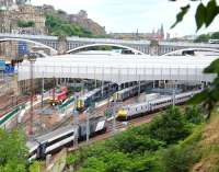 Sunday morning view over the east end of Waverley on 7 July 2013. The East Coast 0900 to Kings Cross waits at platform 2, while the ECS for the 0910 HST to Aberdeen runs into platform 1. (The HST will depart from platform 19 which it will reach via the crossover).  At platform 3 unit 380107 will form the first Sunday train to North Berwick at 1033, while sister unit 380104 is stabled in platform 4. Class 90 and 67 'sleeper' locomotives stand in the adjacent bay.<br><br>[John Furnevel 07/07/2013]