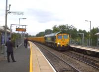 The businessmen on the up platform are obviously not superstitious, as they seem to be enjoying the sight of 66613 heading West through Warwick Parkway towards Birmingham with ballast hoppers on 2nd July.<br><br>[Ken Strachan 02/07/2013]