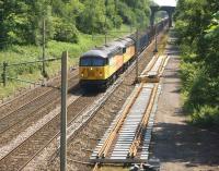 The return trip to Carlisle for the empty wagons from Chirk, heading north at Charnock Richard on a bright and sunny 6 July 2013, with Colas Rail Freight locomotives 56105+56087 in charge.<br><br>[John McIntyre 06/07/2013]