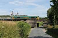 Day 2 of the West Coast Main Line (between Euxton and Warrington) nine day closure in July 2013 saw three Network Rail infrastructure trains from Carlisle to Euxton in quick succession. This is <I>Train No. 2</I>, heading south at Brock behind Freightliner 66555. [See image 30884] for a closer view of the ornante low bridge.    <br><br>[Mark Bartlett 14/07/2013]