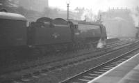 Unrebuilt <I>Battle of Britain</I> Pacific no 34054 <I>Lord Beaverbrook</I> stands at Nottingham Victoria on a grey and misty Saturday 30 March 1963 with a football special from Southampton. [FA Cup quarter final : Nottingham Forest 1 Southampton 1. Southampton eventually went through 5-0 after a second replay]<br><br>[K A Gray 30/03/1963]