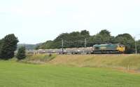 During the July 2013 WCML closure four junctions are being rebuilt between Euxton and Warrington. Regular freights have been diverted but infrastructure trains have been running to the work sites. Freightliner 66549 is seen just north of Brock hauling ballast from Carlisle New Yard to Euxton Junction, the third of three trains that followed each other south on Sunday 14 July.<br><br>[Mark Bartlett 14/07/2013]