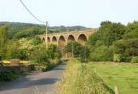 Martholme Viaduct on the former Great Harwood loop line is beautifully preserved although the tracks across it have long gone. Seen on 5 July 2013 the embankment to the right is heavily overgrown although a Lancashire County Council footpath now runs through the trees to Mill Lane on the eastern outskirts of Great Harwood.<br><br>[John McIntyre 05/07/2013]