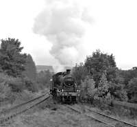 With its train of dmus standing on the running line behind it, Ivatt class 2 46512 runs into Strathmill Distillery Siding. This will allow EE 0-6-0 DM <I>Spirit o' Fife</I> to couple onto the ecs and haul it back into Keith Town station. The 2-6-0 would then work the final train of the day to Dufftown. [See image 43799]<br><br>[Bill Jamieson 13/10/2012]