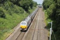 The Royal Train passed through Lancashire on 17 July as part of a visit by HM The Queen to South Cumbria. Here, silver liveried 67026 brings up the rear as the train heads north and is just about to pass under the M55 Motorway on its way to Oxenholme. <br><br>[Mark Bartlett 17/07/2013]