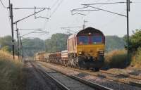 Another infrastructure train, running from one of the WCML sites between Euxton and Warrington, makes its way north at Woodacre behind DBS 66069 on a sunny 17th July 2013.<br><br>[Mark Bartlett 17/07/2013]