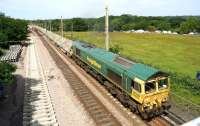 During the first 5 days of the possession a number of freight trains ran through the worksite. On 14 July 2013 Freightliner 66555 brings loaded ballast wagons south over Balshaw Lane Junction heading for one of the sites further south.<br><br>[John McIntyre 14/07/2013]