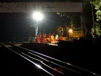 The night shift at the Balshaw Lane Junction worksite on 17 July 2013. Work is in progress preparing the new location for the facing points on the Down line which will give access to the slow line. This is some 200m south of the original location. The night shift had ideal weather conditions compared to the very high temperatures endured by the day shift.<br><br>[John McIntyre 17/07/2013]