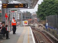 View east from Docklands Light Railway platform 2 at Shadwell on Saturday 20 July 2013, with a train approaching from Limehouse. The station is also served by trains on the London <I>Overground</I> East London Line which, at this particular station, happens to be underground! <br><br>[John Thorn 20/07/2013]