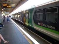 First Great Western labelled London Midland liveried 153333, and a hybrid FGW liveried class 150 3 car set, wait in platform 4 at Cardiff General before running out ECS after arrival from Taunton during the late afternoon of 17 July.<br><br>[David Pesterfield 17/07/2013]