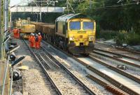 Freightliner 66553 has the honour of being the first locomotive onto the re-laid Down Fast line on 19 July 2013 with empty wagons which will be collecting the recovered rails from the Up line on the left.<br><br>[John McIntyre 19/07/2013]