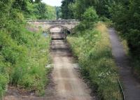 Site of the 1847 station at Eskbank looking north on 18 July 2013. The last of the remains of the old station structures seem to have been demolished and cleared. The pedestrian ramp on the right, which formerly provided access to walkers and cyclists, is now closed off - with nature already starting to show signs of an early reclamation attempt.<br><br>[John Furnevel 18/07/2013]