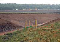 Looking south over a new cutting alongside the A6106 towards the Edinburgh City Bypass on 25 July, with work in hand to create a temporary diversion to allow breaching for the rail route.<br><br>[Bill Roberton 25/07/2013]