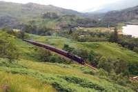 The Glenfinnan Station Museum with the aid of volunteers has constructed a footpath from the station to a viewpoint overlooking the famous viaduct. This view is just off the top of the path above the station, looking over The Glenfinnan Monument and Visitor Centre on 23 July, as Black 5 No.45407 brings the afternoon <I>Jacobite</I> into Glenfinnan Station.<br><br>[John Gray 23/07/2013]