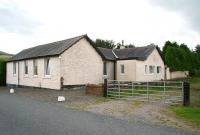 The former station at Killywhan on the Port Road between Dumfries and Castle Douglas (closed to passengers 1950). Photographed  on 1 September 2009 looking south west from the site of the level crossing towards Dalbeattie. The building has been modified considerably since final closure of the line in 1965 and now extends over much of the platform, part of which can still be seen beyond the gate.<br><br>[John Furnevel 01/09/2009]