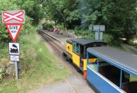 R&ER diesel <I>Perkins</I> goes cautiously across the level crossing and in to Eskdale Green station with a train for Dalegarth. Although it appears under that name in some literature and on maps the name boards on the platform simply show The Green and the two names have both been used at various times over the railway's life. <br><br>[Mark Bartlett 27/07/2013]