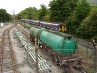 156453 and 156447 run past the oil depot on their approach to Fort William station on the 10.10 ex Mallaig to Glasgow service on 25 June.<br><br>[David Pesterfield 25/06/2013]