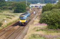 185112 heads west from Kirkham on 27 July 2013  on its way from Manchester Airport to Blackpool North. In the background 185117 on the reverse service has just crossed from the through line in order to call at Kirkham and Wesham station. Above the nearer 185 is a surviving abuttment of the flyover that once carried the line from Blackpool Central. Beyond that Kirkham signal box can just be seen.<br><br>[John McIntyre 27/07/2013]