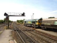 Freightliner 66530 runs out of the west end throat for platform 4 and adjacent through line at Bristol Parkway with a rake of coal wagons on 15 July 2013.<br><br>[David Pesterfield 15/07/2013]
