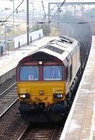 66104 passes through Prestonpans station with the 6E30 Dalzell - Tees Yard steel empties on 25 July 2013.<br><br>[Bill Roberton 25/07/2013]