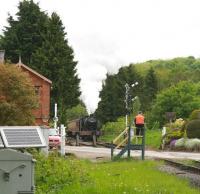 The long wait. The signalman at New Bridge level crossing waits patiently for the 11.30 from Grosmont on 1 June 2013 in order to complete the token exchange. The train had stopped briefly alongside the PW depot for reasons unknown and B1 4-6-0 61002 <I>Impala</I> (aka 61264) is restarting for the final section to Pickering station.<br><br>[John Furnevel 01/06/2013]