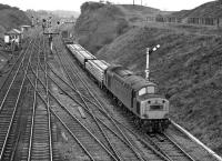 Judging by the procession of engineer's trains which passed Goose Hill Jn around lunchtime on Saturday 12th February 1977, there must have been relaying scheduled somewhere in the Leeds area that weekend. The first of these to appear, at 12.47, was a short train of prefabricated track panels with 40169 from Healey Mills in charge.<br><br>[Bill Jamieson 12/02/1977]