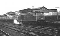 Late on a gloomy January afternoon in 1970, Hymek D7031 awaits its departure time at Cardiff General with the 16.35 to Portsmouth Harbour.  <br><br>[Bill Jamieson 17/01/1970]