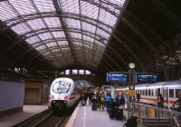 An ICE3 unit forming part of the 12.51 Intercity-Express departure to Dresden rests under Leipzig Hauptbahnhof's impressive train shed on 30th June 2013. To the right, passengers make cross-platform interchange from the 07.11 Munich-Berlin Intercity service.<br><br>[David Spaven 30/06/2013]