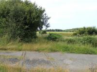 Looking west along the remains of the short Eskmeals (Vickers Gun Range Sidings) branch to the coastal ranges that are still in use today and can be seen in the distance. Opened by the Furness Railway in 1897 and still in regular use in-the 1980s but believed to have been lifted in mid 1990s. [With thanks to all who responded] [See image 44057] for a view in the opposite direction. Level crossings map reference SD088925<br><br>[Mark Bartlett 27/07/2013]