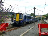 The 11.48 ex-Glasgow Central creeps to a halt at Largs station on 31 July 2013.<br><br>[Colin Miller 31/07/2013]
