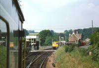 A Barnstaple bound DMU approaching Eggesford loop on a summer Saturday in June 1984. A returning class 33 hauled set is waiting on the other side of the crossing for the DMU to clear the line to Crediton.<br><br>[John Stanford 16/06/1984]