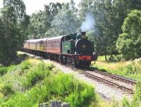 The Strathspey special approaching Broomhill on 3 August 2013 conveying guests involved in the Highland Railway 150 year celebrations. Vintage buses then carried all to the site of Grantown-on-Spey West Station where a parade took place, ending at Grantown museum. [See image 44060]<br><br>[John Gray 03/08/2013]