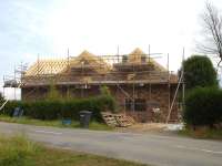 The extent of the rebuild of the former crossing keepers cottage at Alne  in this updated view shows how the original structure (centre section) has been extended. [See image 43262]<br><br>[David Pesterfield 27/07/2013]