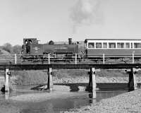 The last of the VoR locos to lose BR blue was No. 7, which reverted in 1983 to a variation on lined BR green . However the name and number plates stayed in the same positions and the BR heraldic device was applied to the cab sides. <I>Owain Glyndwr</I> crosses the Rheidol bridge at Llanbadarn while returning to Aberystwyth  from Devil's Bridge on 4 November 1988. The black flags mark it being the last day of scheduled BR operation prior to privatisation.<br><br>[Bill Jamieson 04/11/1988]