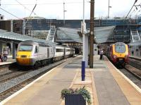 Changing face of Haymarket - scene on 9 August 2013 looking east. On the left is the East Coast 09.52 Aberdeen - Kings Cross, on the right the Virgin Trains 08.20 Birmingham New Street - Edinburgh Waverley.<br><br>[John Furnevel 09/08/2013]