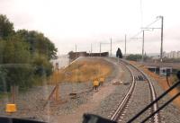 On the single line section about to climb over the Network Rail lines on the Northern approach to Rochdale on 31 July 2013. On the left is the stop board and the remains of the route of the Oldham loop line. Beyond this the track is now used as a turnback siding for services coming out of Manchester.<br><br>[John McIntyre 31/07/2013]