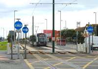 <I>Then, Then and Now</I> at the new Stanley Road tram stop in Fleetwood as <I>Flexity</I> 015 approaches the town from Blackpool. [See image 36360] from 2011 since when the stop has been completed, as has the new Fleetwood Fire Station.<br><br>[Mark Bartlett 10/08/2013]