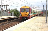 Scene at Edinburgh Park on 6 August 2013 as the 12.21 Edinburgh Waverley - Helensburgh Central pulls away from platform 2 westbound.<br><br>[John Furnevel 06/08/2013]