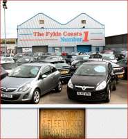 I've driven past this car showroom many times without knowing its<br>
provenance but with the aid of an old book I realised that it was the original Blackpool & Fleetwood Tram Depot. The outside is covered in cladding but two holes have been left to show the inscribed stones underneath. An enlargement of the stone on the left is reproduced here (the other says <I>Jubilee 1897</I>). The depot had a capacity for 41 trams but finally closed in 1963. [Update: During 2016 the old tram depot was demolished but I understand the plaques have been saved.] <br><br>[Mark Bartlett 10/08/2013]