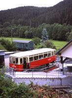 Passengers board the Oberweissbacher Bergbahn's standard-gauge passenger coach (carried piggyback on a 1.8m gauge Rollwagen) at the Obstfelderschmiede terminus on 29th June 2013. Note the elderly Deutsche Bahn wagon on the chord siding linking to the adjacent Schwartzatalbahn.<br><br>[David Spaven 29/06/2013]