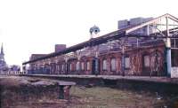 A 1980s photograph showing platform 1 at Manors North. The lines through platforms 1 and 2 ran through to join the ECML just beyond Manors East in the background. The station clock tower still stands above the station building. [See image 18389]<br><br>[Ian Dinmore //]