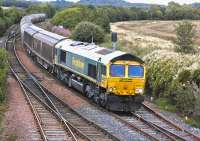 Freightliner 66617 passes Inverkeithing East Junction with the late-running 6B32 Aberdeen - Oxwellmains cement empties on 12 August.<br><br>[Bill Roberton 12/08/2013]