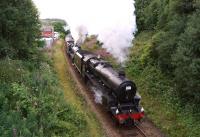 The return leg of the <I>15 Guinea Special</I> from Carlisle to Manchester was hauled by a pair of Black 5s. In 1968 this had been 44781 and 44871 but on 11 August 2013 45231 and 44932 did the honours. The train is running ahead of time and digging into the climb from a stop at Darwen on the journey south towards Sough tunnel. Part of the building on the left is the remains of Spring Vale station [see image 33698].<br><br>[John McIntyre 11/08/2013]