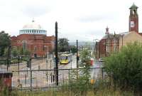 Another temporary terminus. 3008 stands at the tram stop known as Rochdale Rail Station before returning via Oldham to Manchester then East Didsbury. Construction work continues to take the trams on from here down into the town centre.  This image taken from the island platform of the main line station.<br><br>[Mark Bartlett 31/07/2013]