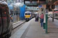 A busy scene at Waverley platforms 8 and 9 on 13 August 2013. CrossCountry 221136 forms the 15.08 to Plymouth, 334027 the 14.48 to Helensburgh Central and Pendolino 390114 the 14.51 <I>Festival extra</I> to London Euston.<br><br>[Bill Roberton 13/08/2013]