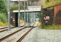 There is less vegetation around since the conversion of the Oldham loop to Metrolink, just compare this photo with the same location in the autumn of 2009 [see image 26458]. On 31 July 2013 a Rochdale bound tram climbs the hill from Oldham on the approach to Derker.<br><br>[John McIntyre 31/07/2013]