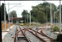 The junction at St Werburgh's Rd, where the new Metrolink line to Manchester Airport diverges, was complete in 2013 although not yet connected to tracks on the branch itself. View from behind the driver of a tram taking the recently reopened <I>Midland Main Line</I> to East Didsbury. <br><br>[Mark Bartlett 31/07/2013]