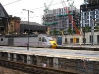 East Coast 43317 stands at Kings Cross platform 7, with the ornate canopy supports rising above platform 8. The suburban platforms are beyond with the lower train shed roof running across platforms 9-11.<br><br>[David Pesterfield 09/08/2013]